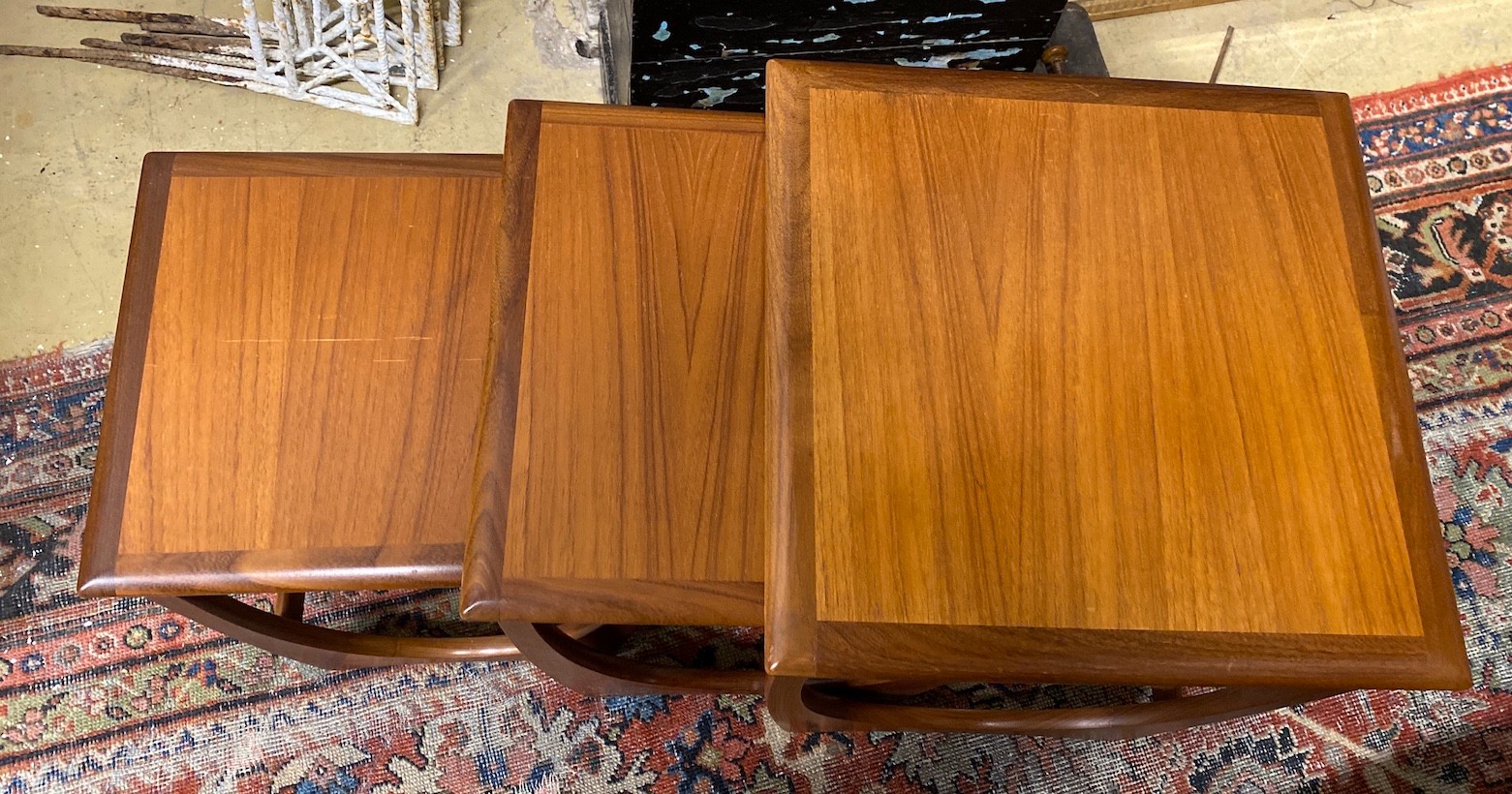 A nest of three G-Plan teak tables, width 50cm, depth 50cm, height 50cm